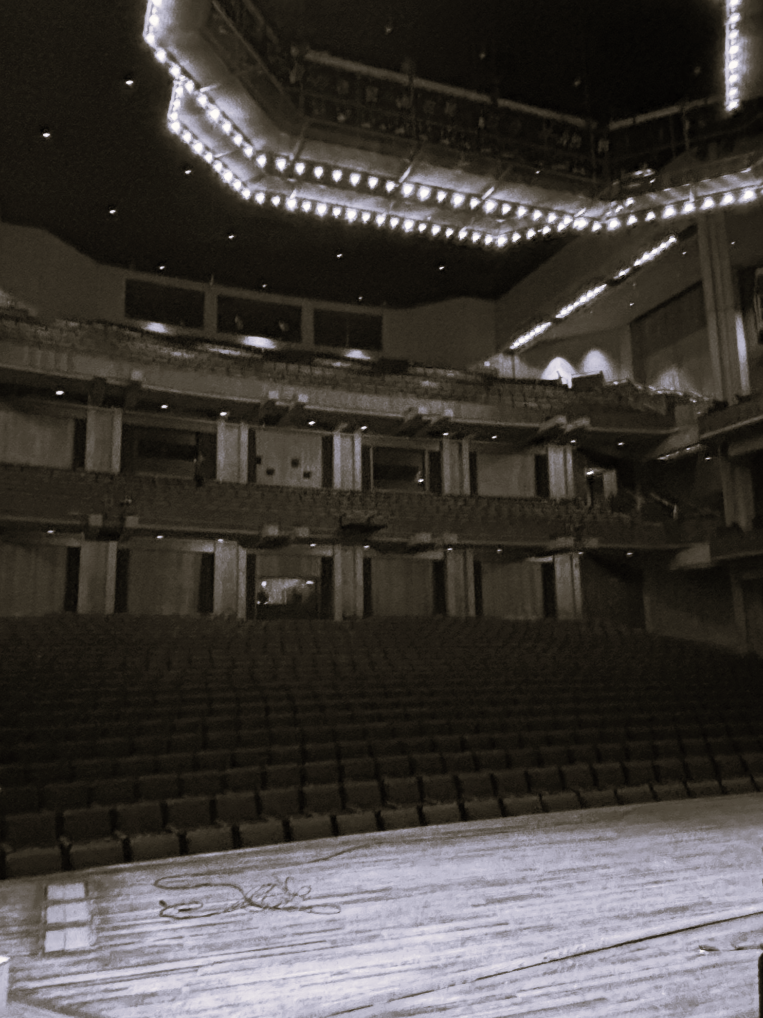 View from the stage of a concert hall looking out over rows of empty seats